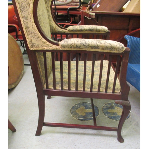 237 - An Edwardian mahogany framed porter style chair, upholstered in a flora fabric, raised on cabriole l... 