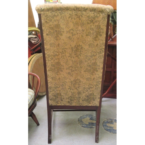 237 - An Edwardian mahogany framed porter style chair, upholstered in a flora fabric, raised on cabriole l... 