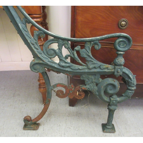 238 - A pair of late Victorian blue painted cast iron bench ends 