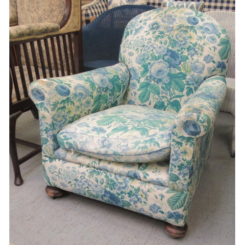 240 - An Edwardian mahogany framed salon chair with a floral fabric upholstered back and seat, raised on m... 