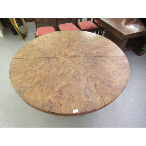 244 - A 19thC walnut tip-top table, the segmented, figured top over a tapered octagonal, bulbous pedestal,... 