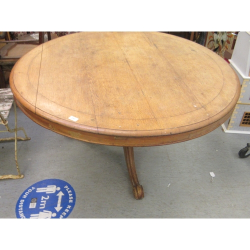 249 - A late 19thC oak tip-top table, over an octagonal bulbous pedestal, raised on a cabriole tripod base... 