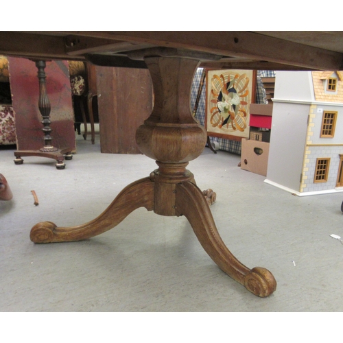 249 - A late 19thC oak tip-top table, over an octagonal bulbous pedestal, raised on a cabriole tripod base... 