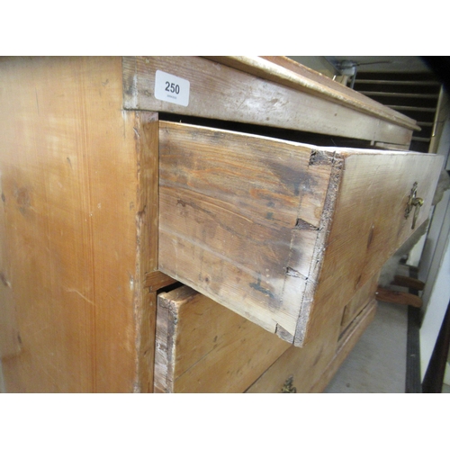 250 - An early 20thC waxed pine sideboard with a bank of three graduated drawers and an adjacent panelled ... 