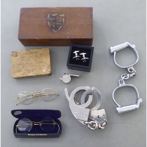 253 - A mixed lot: to include a black painted steel deed box and two pairs of handcuffs