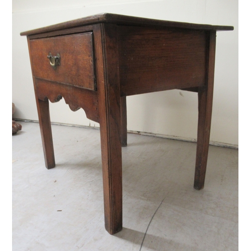 255 - An early 19thC oak lowboy with a single deep drawer and brass bail handle, over a fretworked apron, ... 