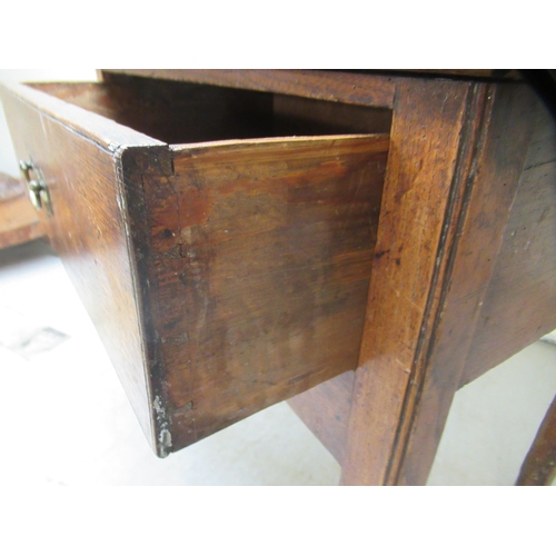 255 - An early 19thC oak lowboy with a single deep drawer and brass bail handle, over a fretworked apron, ... 