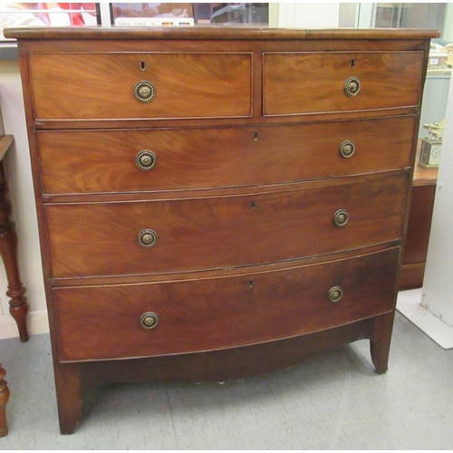 256 - An early 19thC mahogany bow front dressing chest with two short/three graduated long drawers, raised... 