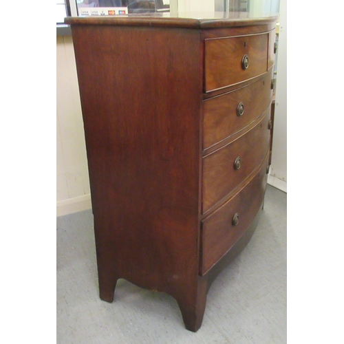 256 - An early 19thC mahogany bow front dressing chest with two short/three graduated long drawers, raised... 