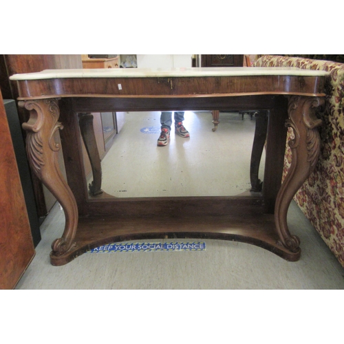 257 - A late Victorian walnut framed serpentine front serving table, the top set with a marble panel, rais... 