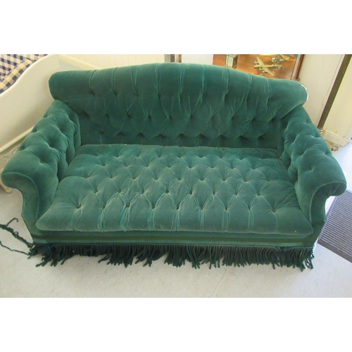 265 - A modern Chesterfield style two person settee, button upholstered in green dralon with a tasselled f... 