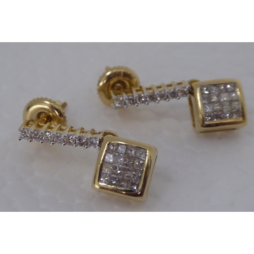 283 - A pair of gold coloured metal pave set diamond pendant earrings 