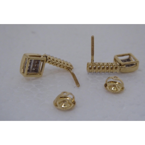 283 - A pair of gold coloured metal pave set diamond pendant earrings 