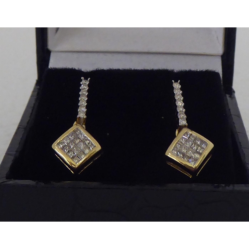 283 - A pair of gold coloured metal pave set diamond pendant earrings 