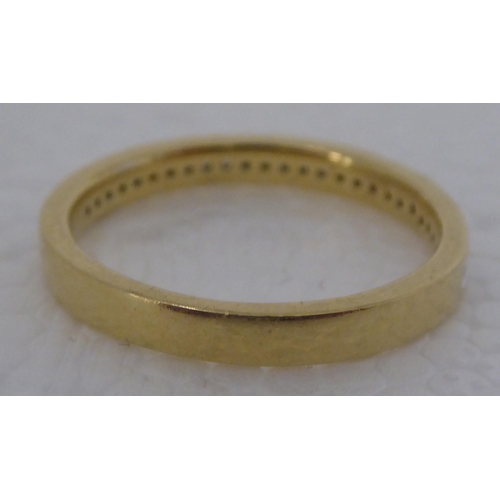 297 - A gold coloured metal, rubover set diamond half eternity ring  stamped 750 