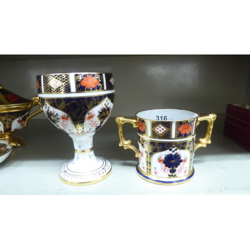 316 - Royal Crown Derby china collectables, decorated in the Imari palette: to include a pedestal goblet