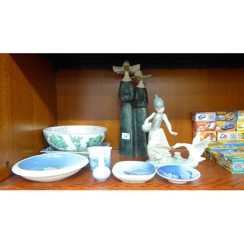 354 - Ceramics: to include a Lladro porcelain model, a girl and swan  8.5