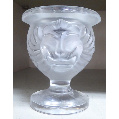 378 - A modern Lalique glass pedestal candle holder, fashioned as an urn with opposing lion mask ornament ... 