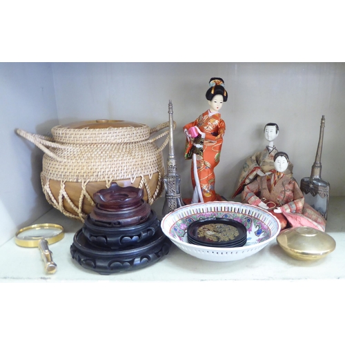 380 - 20thC Asian collectables: to include hardwood stands; and dolls  largest 11