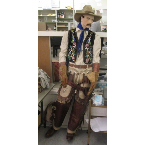 66 - A male life-size mannequin, dressed as a cowboy  78