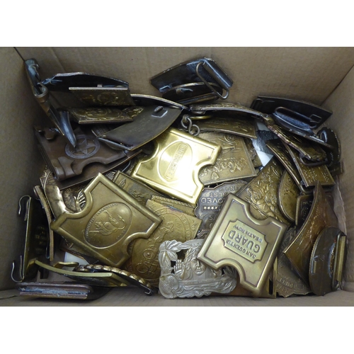 72 - A collection of variously themed reproductions American cast metal plates; and belt buckles