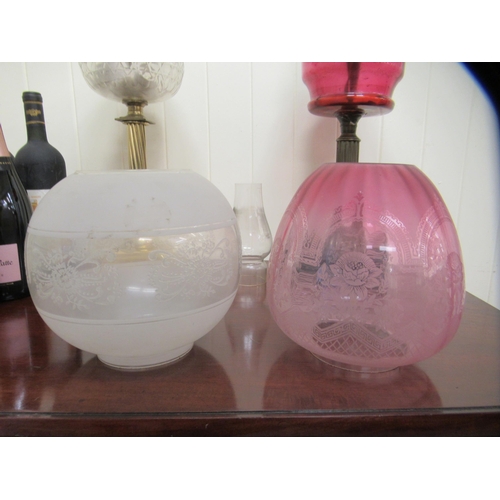 86 - A late Victorian oil lamp with a cranberry coloured glass reservoir  16