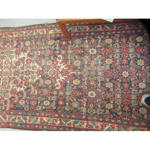 103 - A Persian runner, decorated with floral motifs, on a red and blue ground  196