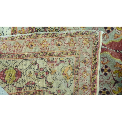 218 - A Persian rug, decorated in colours and traditional designs  75