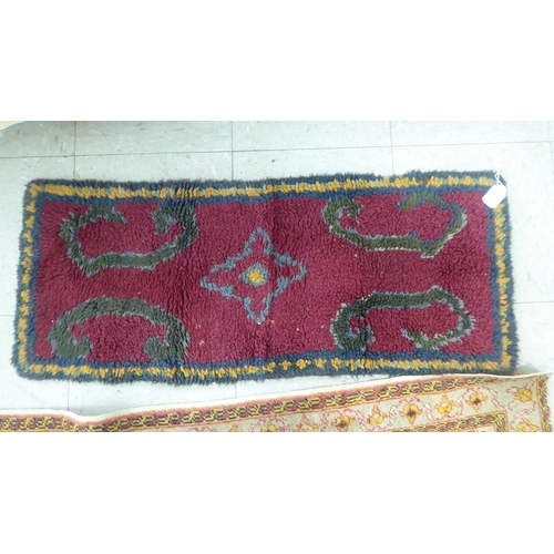 218 - A Persian rug, decorated in colours and traditional designs  75