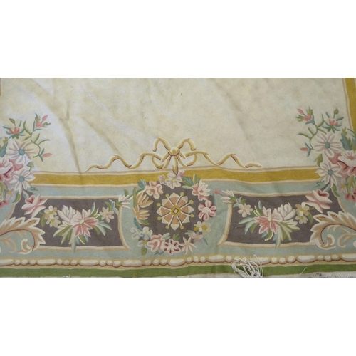 219 - A crewel worked rug, decorated in pastel colours with floral designs  60