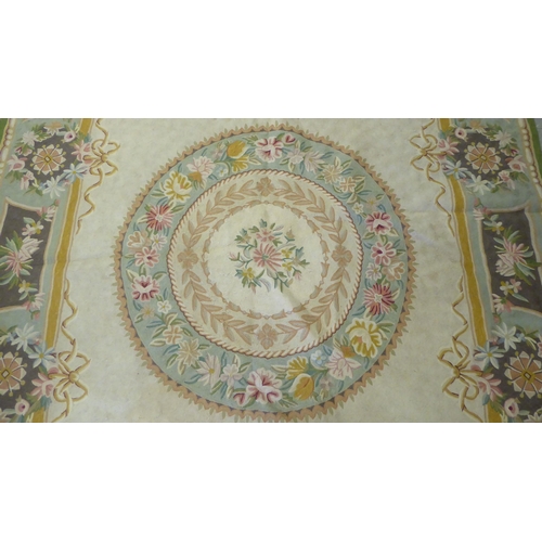 219 - A crewel worked rug, decorated in pastel colours with floral designs  60