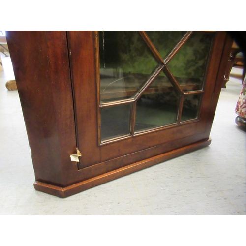 224 - A George III mahogany hanging corner cabinet with a single astragal glazed door  38