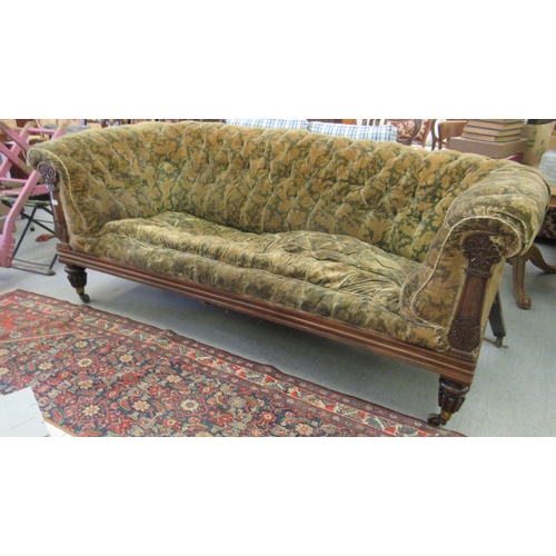 242 - A Regency rosewood framed salon settee, button upholstered in a gold floral fabric, raised on turned... 