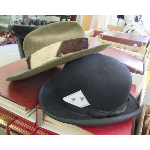 254 - Gentlemen's hats, viz. a black bowler, two black silk top hats, a red fez, a patterned and gilded tu... 