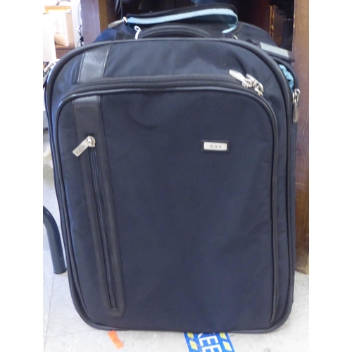 344 - Tumi luggage: to include a black canvas cabin bag; and a William & Son canvas bag 