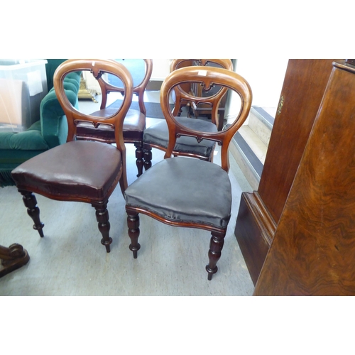 231 - A set of four late Victorian mahogany framed balloon back dining chairs with blue faux hide upholste... 