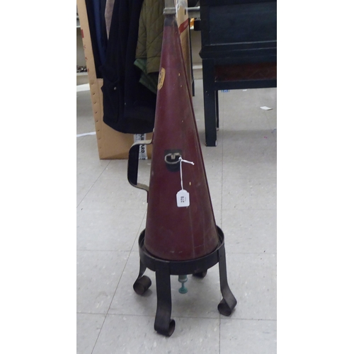 278 - A vintage Minimax cone shaped fire extinguisher, on an associated wrought iron stand 