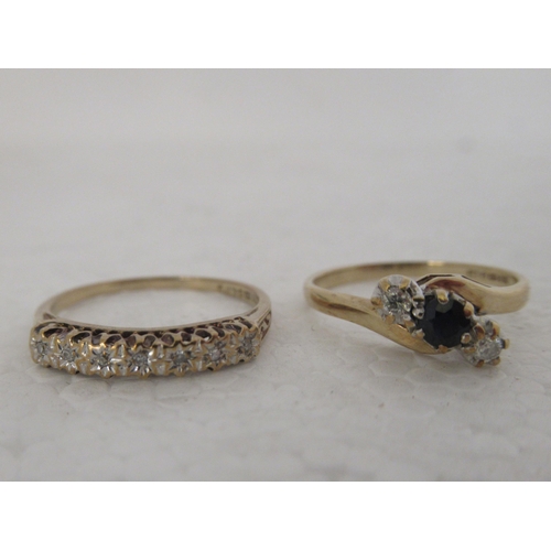 313 - A 9ct gold ring, set with a sapphire, flanked by two diamonds; and another set with diamonds