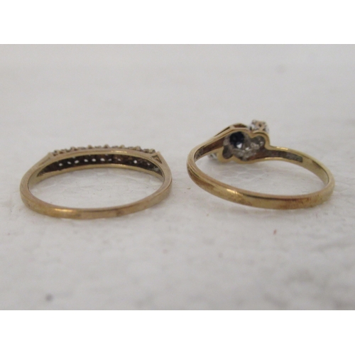 313 - A 9ct gold ring, set with a sapphire, flanked by two diamonds; and another set with diamonds