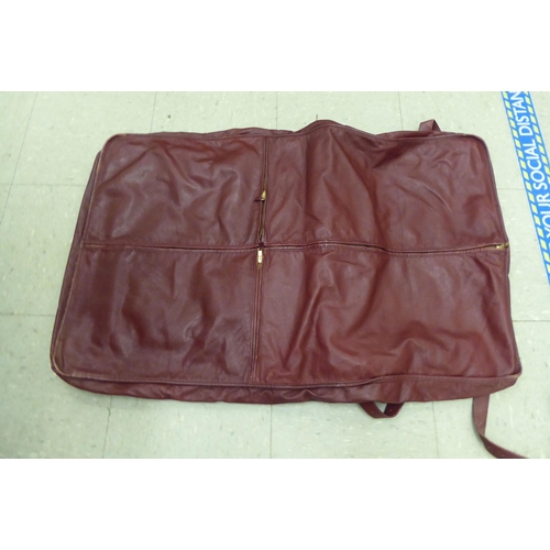 347 - A Cartier red leather garment carrier 