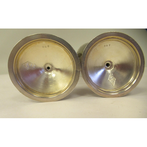 15 - A pair of late 19thC silver Gothic inspired goblets with uniformly engraved decoration, each ovoid s... 