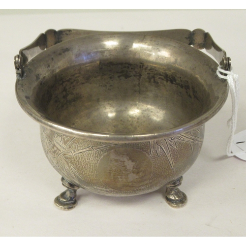 17 - A 1920s Chinese Zee Sung silver engraved sugar basin of cauldron form with a flared rim and swing ha... 