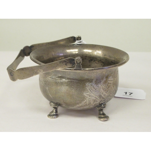 17 - A 1920s Chinese Zee Sung silver engraved sugar basin of cauldron form with a flared rim and swing ha... 