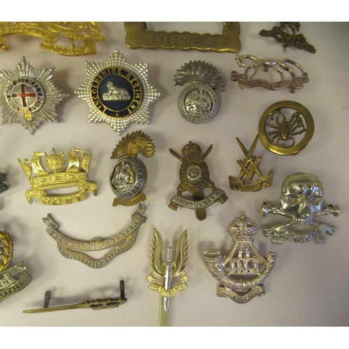25 - Approx. thirty-two military cap badges and other insignia, some copies: to include the 4th Cheshire ... 