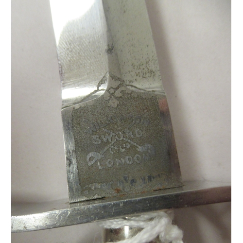 26 - An FS fighting knife with a textured hilt, the Wilkinson blade 6.75