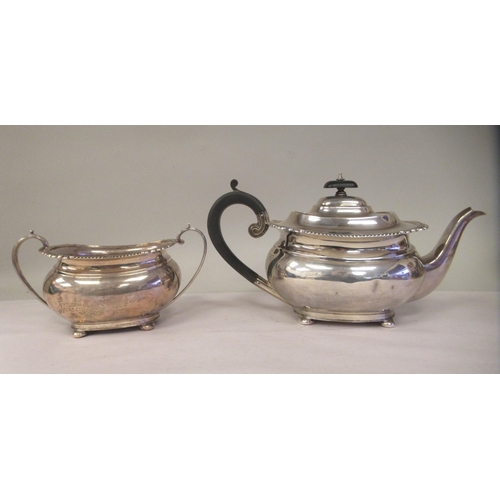 3 - A silver teapot of oval, bulbous form with dragooned and shell cast decoration, a swept spout, insul... 