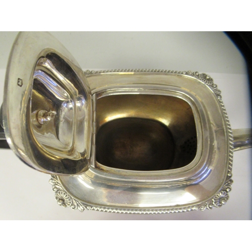3 - A silver teapot of oval, bulbous form with dragooned and shell cast decoration, a swept spout, insul... 