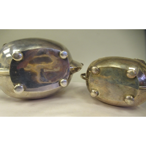 3 - A silver teapot of oval, bulbous form with dragooned and shell cast decoration, a swept spout, insul... 