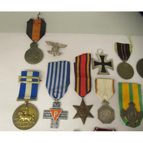 32 - Various 20thC British and foreign medals, medallions and ribbons, some copies: to include a German I... 