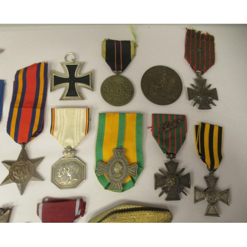 32 - Various 20thC British and foreign medals, medallions and ribbons, some copies: to include a German I... 